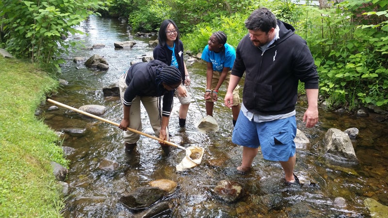 Harlem Academy students doing research in a stream