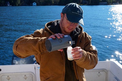 Researcher Collecting samples of zooplankton from the lake.