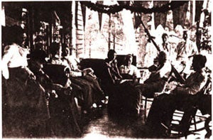 Early photograph of Moore family sitting on porch