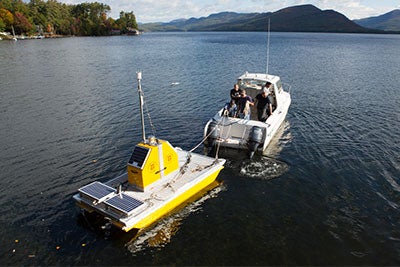 Boat pulling a yellow ertical profiler.