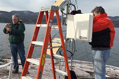 Installing a weather station on Gull Rock.